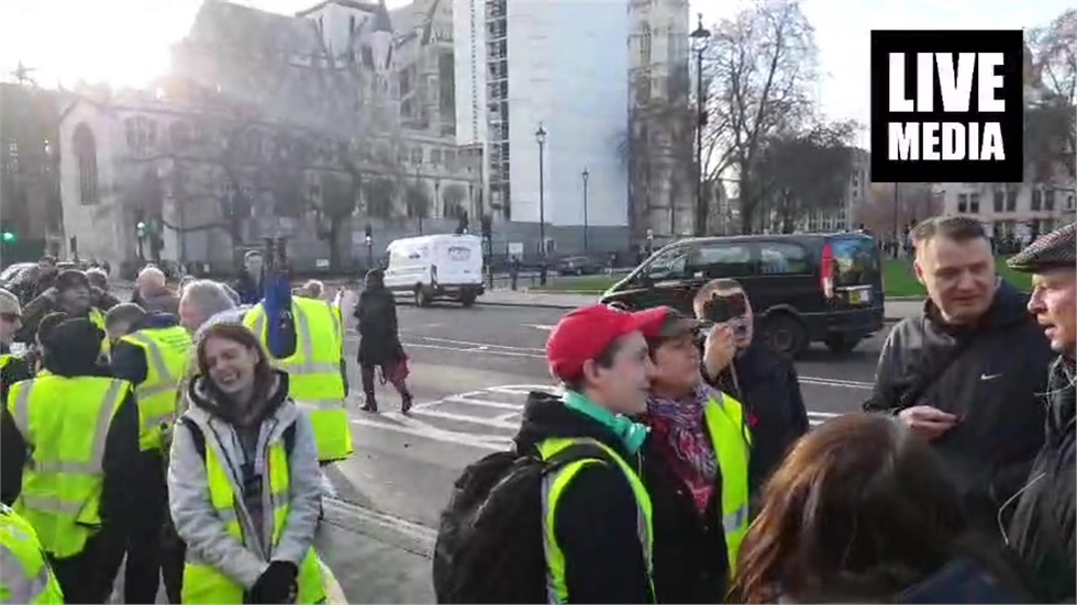 A group of people outside UK Parliament is demanding 