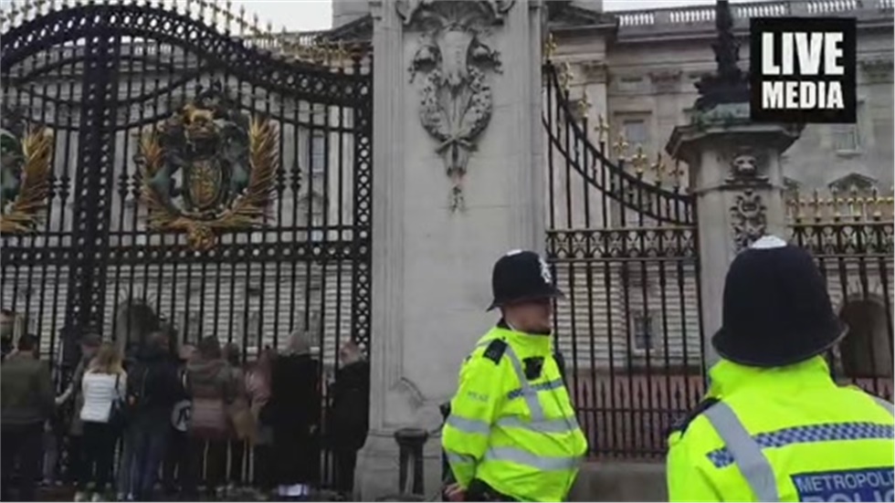 People are queuing outside Buckingham Palace, to photograph the...